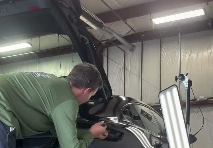 Sean Miller performing paintless dent repair inside the SG PDR shop
