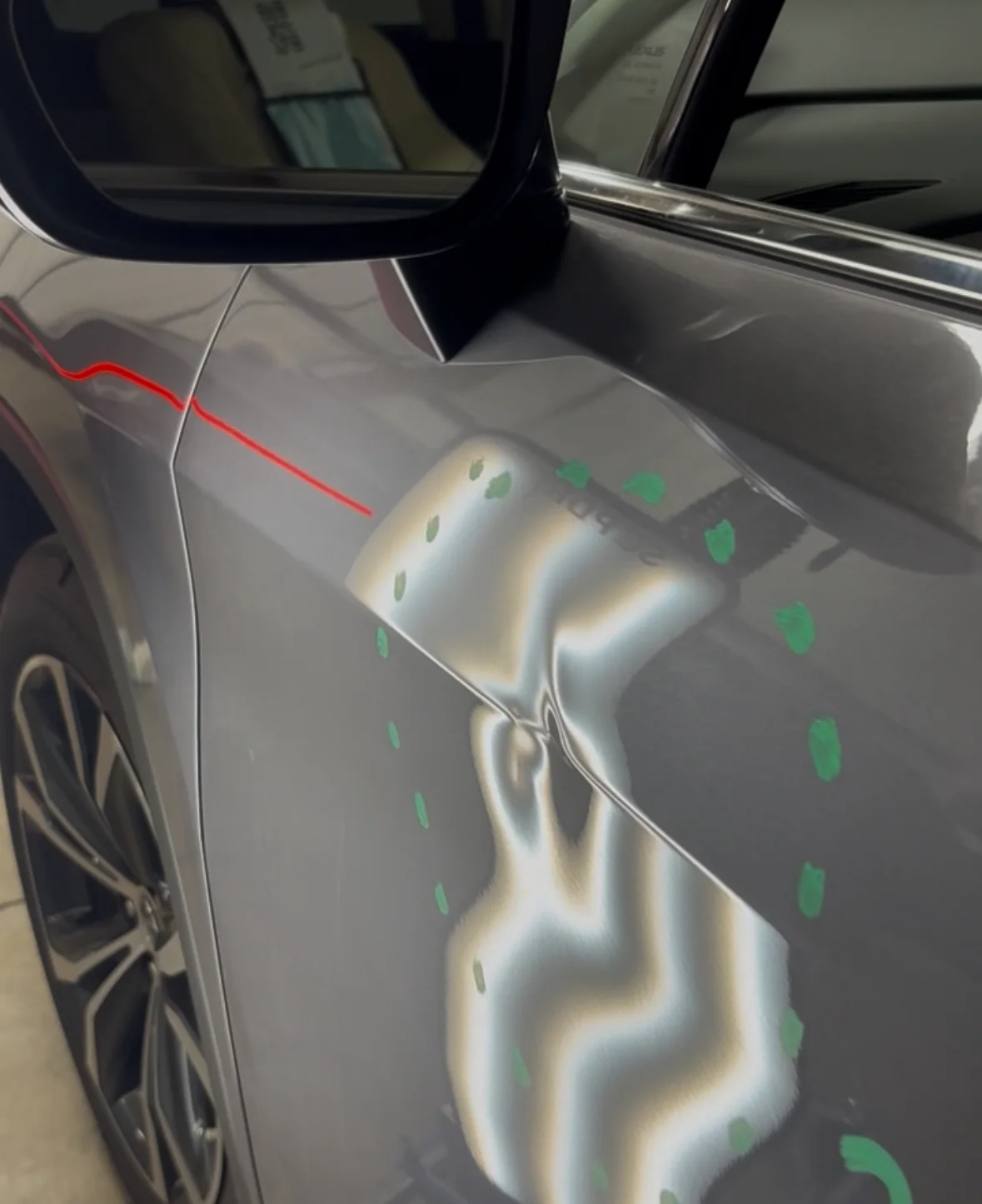 Before repair: a mapped dent distorting the reflection lines on a gray vehicle door